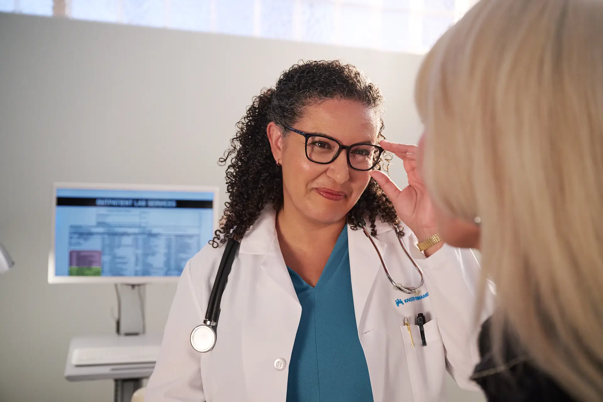 Doctor with glasses looking at patient