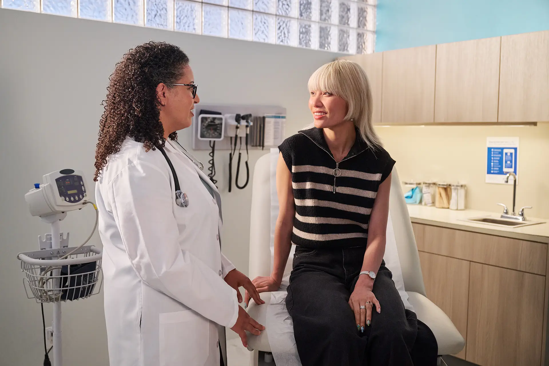 Doctor and patient talking in an exam room.